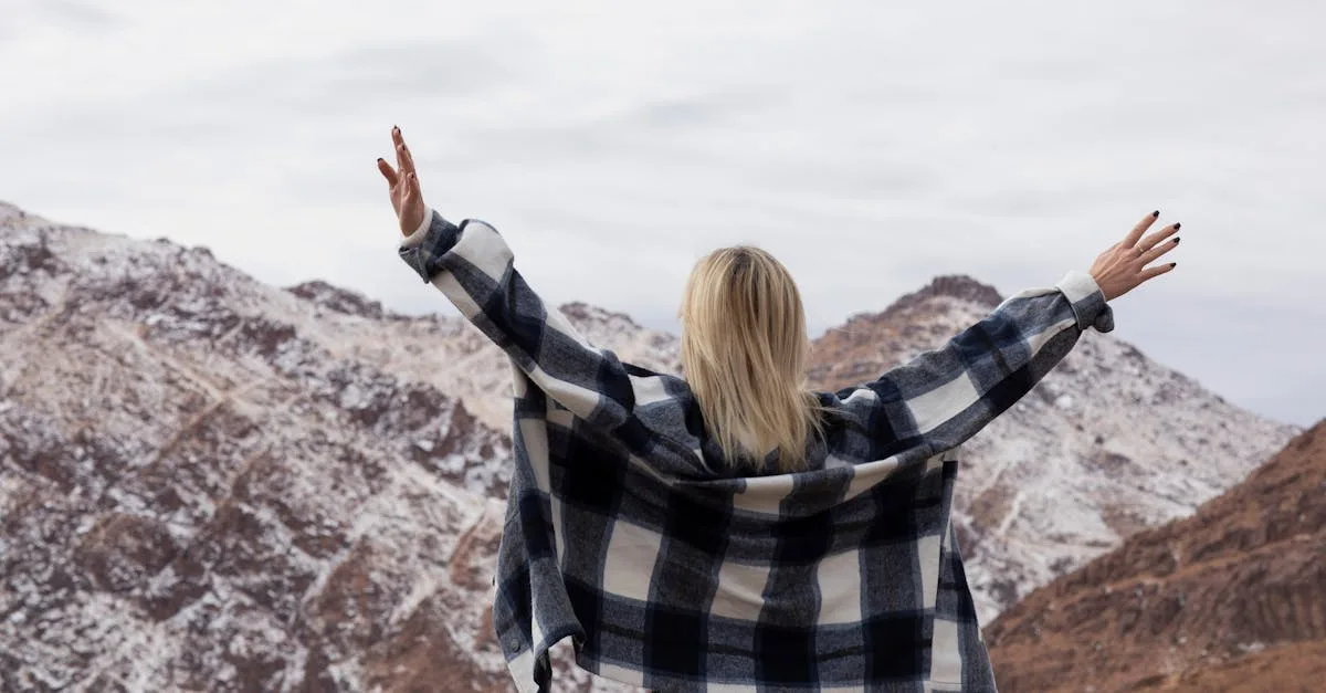 Woman standing in front of mountains, representing how to heal from religious trauma