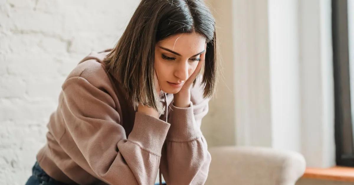 Woman looking down, representing common signs of religious trauma