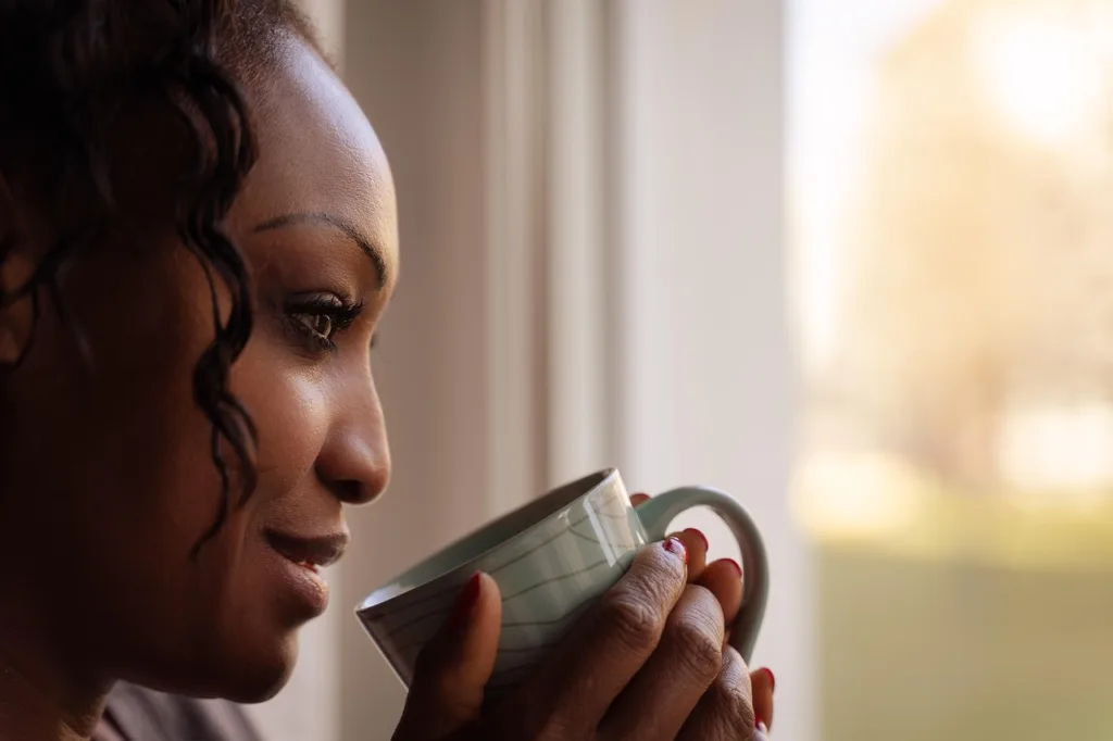 woman, drinking, coffee, morning, female, portrait, looking out the window, poc, bipoc