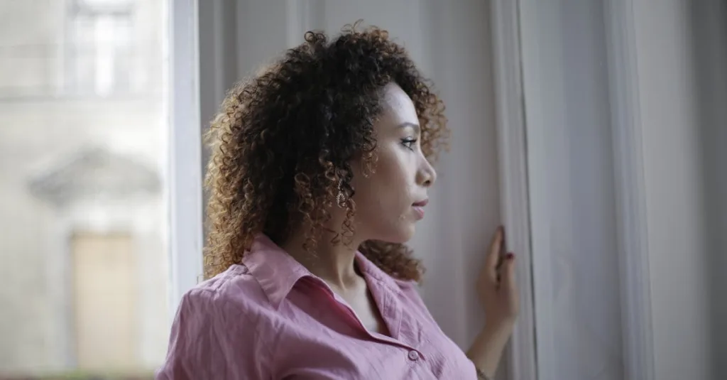 woman looking out window reflecting on family dynamics