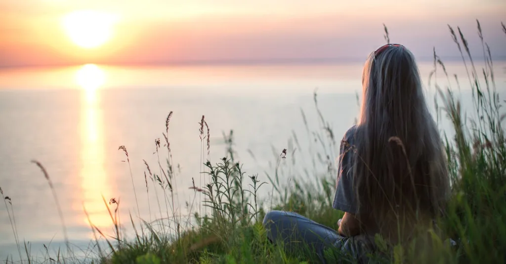 A woman sitting peacefully after therapy with allison riley, lpc